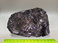 a black rock with glistening crystal surfaces of horneblende and pyroxene